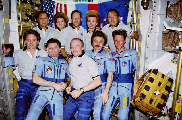 NASA image: Group portrait of STS-84 and Mir 23 crewmembers in the Spacehab