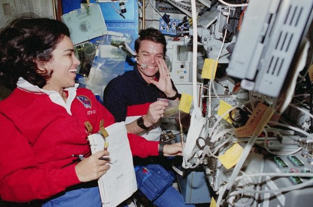NASA image: USMP-4 MGBX, Chawla and Kregel work with glovebox