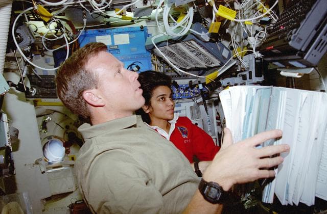 NASA image: USMP-4 MGBX, Lindsey and Chawla work with a glovebox experiment