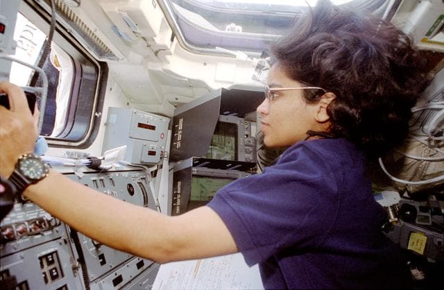 NASA image: Chawla is photographed at the aft flight deck station controlling the RMS