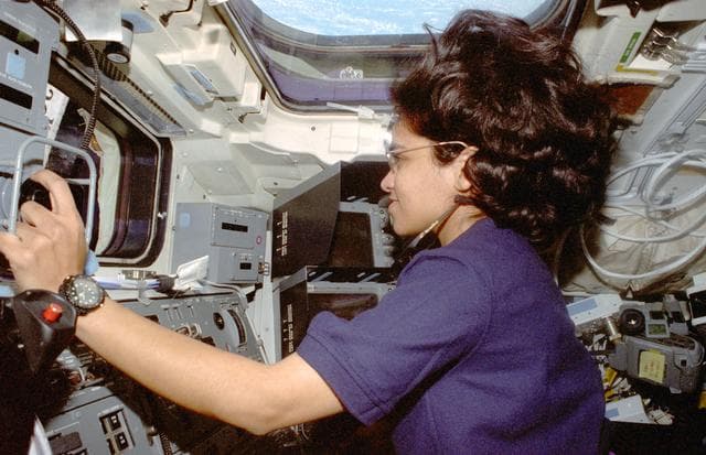 NASA image: Chawla is photographed at the aft flight deck station controlling the RMS