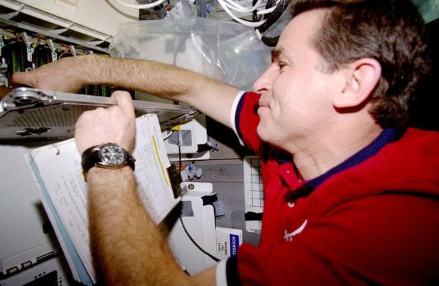 NASA image: CUE - Kadenyuk checks the status of the PGCs in the middeck PGF locker