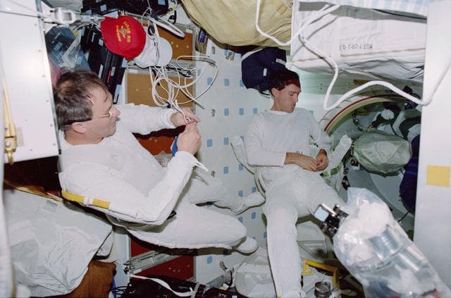 NASA image: View of the STS-88 crew on the flight deck and middeck