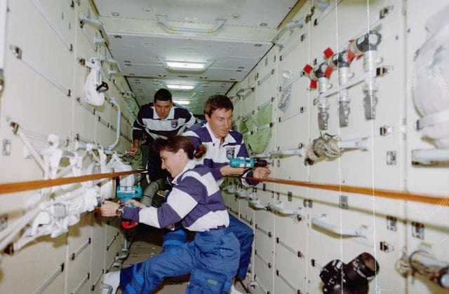 NASA image: Currie and Krikalev pull launch restraint bolts in the FGB/Zarya module