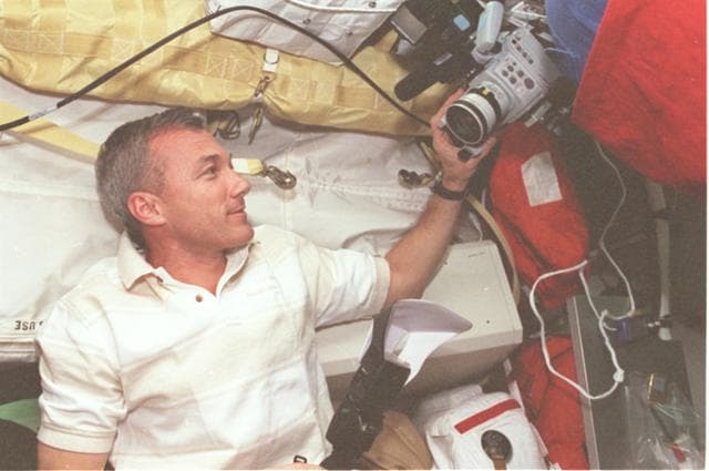 NASA image: Cdr. Wilcutt adjusts a camcorder on middeck