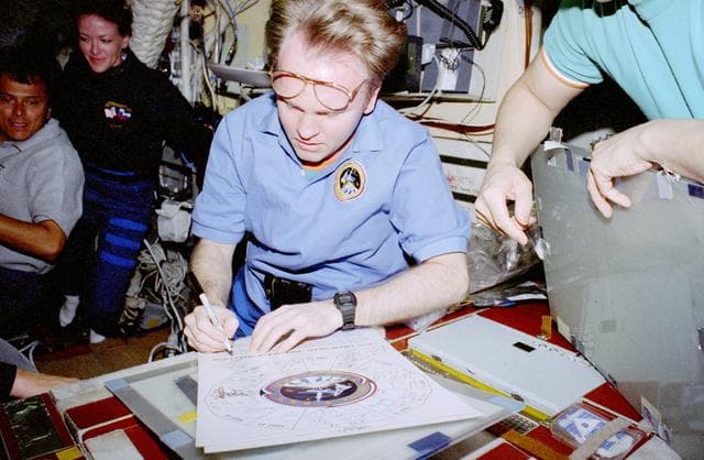 Crewmember activity in the middeck and Mir Space Station Base Block