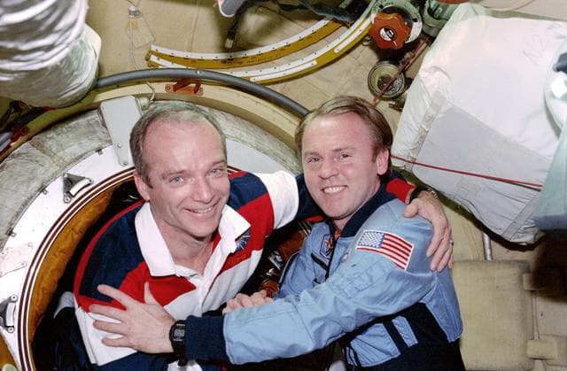 NASA image: STS-91 crew is greeted at the hatch by Mir 25 crewmembers