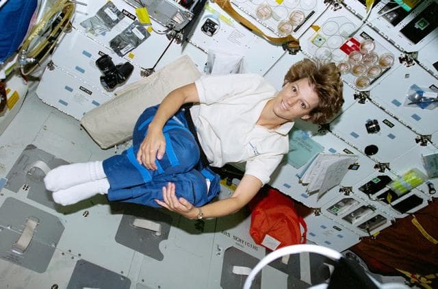 NASA image: STS-93 Commander Collins demonstrates her weightlessness on the middeck