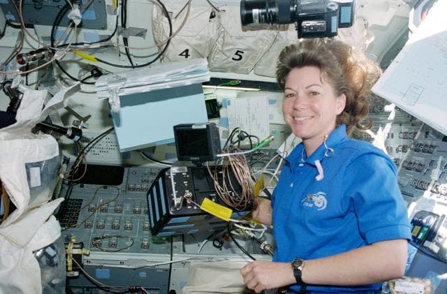 NASA image: STS-93 MS Coleman sets up the HD camera on the flight deck of Columbia