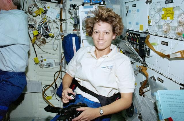 NASA image: STS-93 Commander Collins uses a digital camera on the middeck of Columbia
