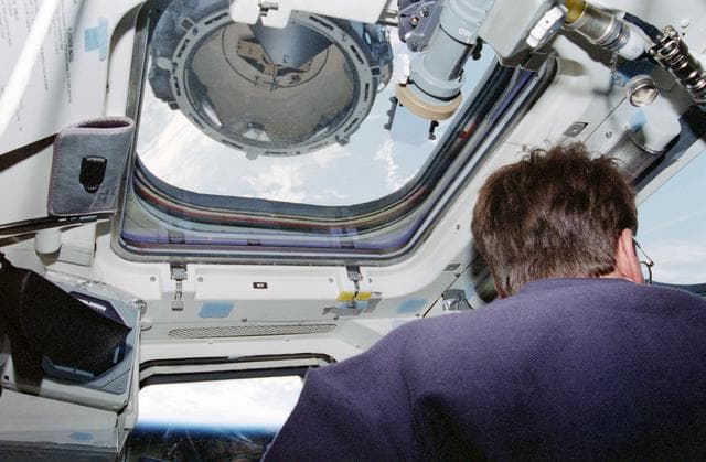 NASA image: Kent Rominger at aft flight deck controls during docking