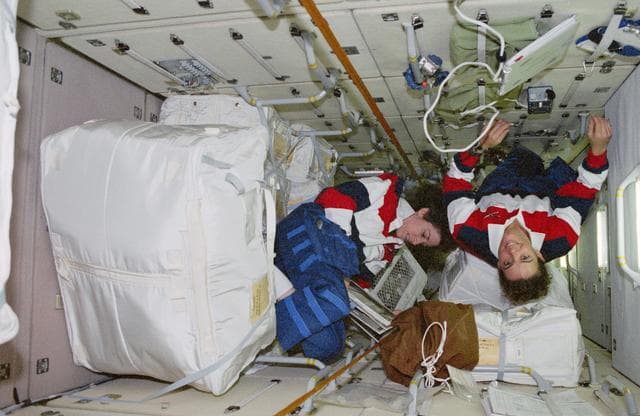 NASA image: Ellen Ochoa and Julie Payette transfer stowage into FGB/Zarya module