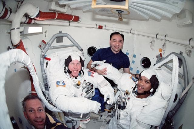 NASA image: MS Jones and MS Curbeam suited in EMU in the A/L for EVA 3