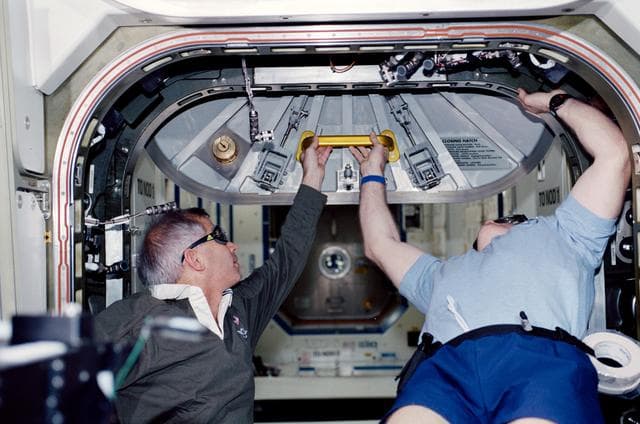 NASA image: STS-98 and Expedition One crew prepare to open U.S. Lab hatch