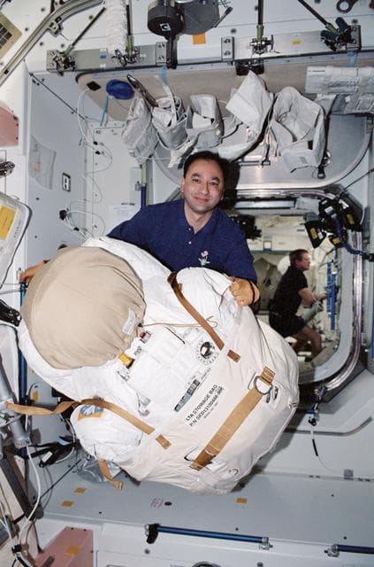 NASA image:   Polansky with EMU stowage bag