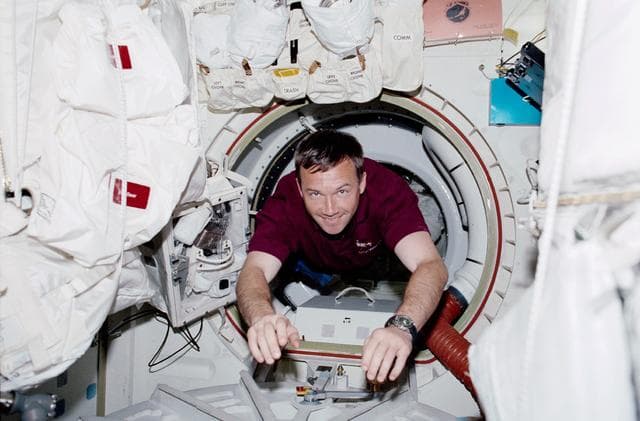 NASA image: MS Lonchakov drifts through the airlock of Endeavour during STS-100
