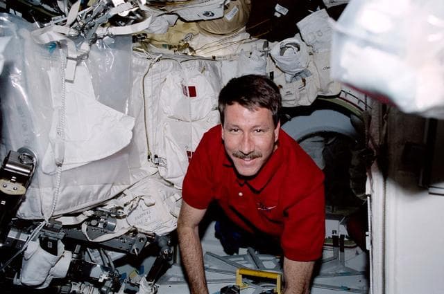 NASA image: Commander Rominger secures the airlock hatch on Endeavour's middeck during STS-100