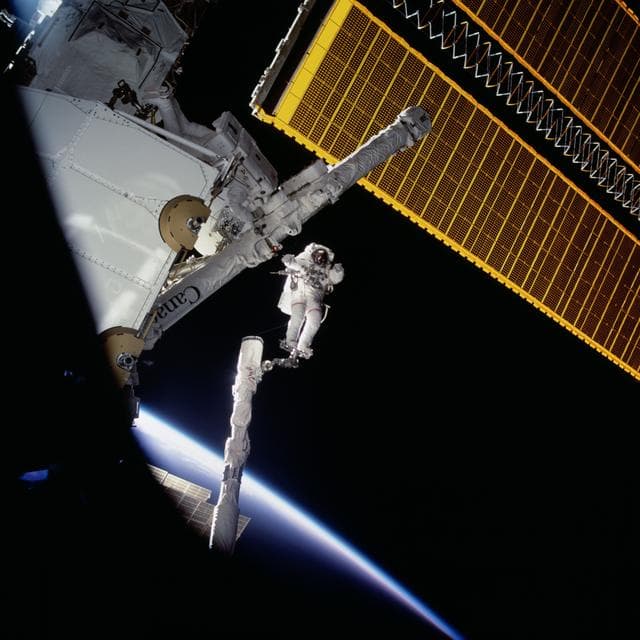NASA image: MS Hadfield and MS Parazynski raise the SSRMS from the SLP during an EVA for STS-100