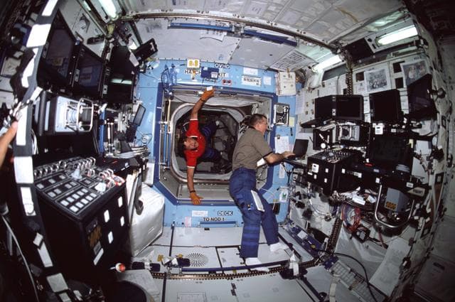 NASA image: Horowitz floats into the ISS U.S. Laboratory/Destiny module where Voss is typing