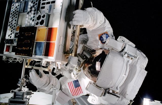 Forrester opens a MISSE PEC installed on the ISS Airlock