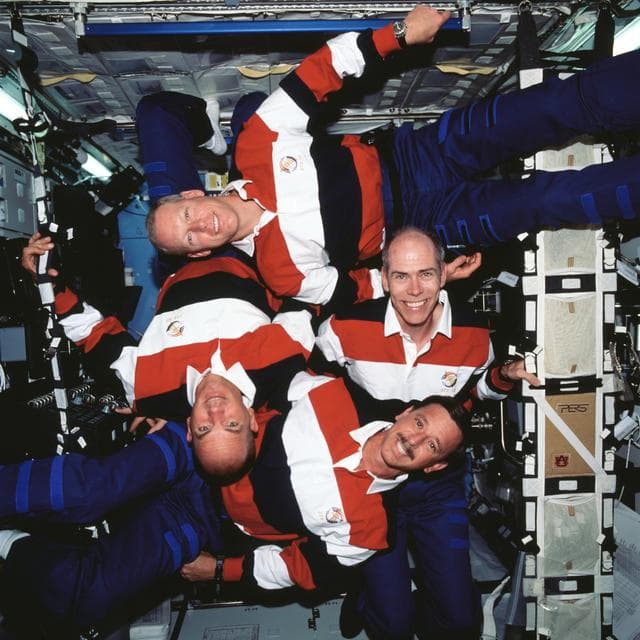NASA image: STS-105 crew in a group portrait in the ISS U.S. Laboratory/Destiny, pinwheel shape