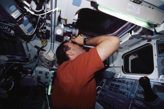 NASA image: STS-109 CDR Altman on aft flight deck with binoculars
