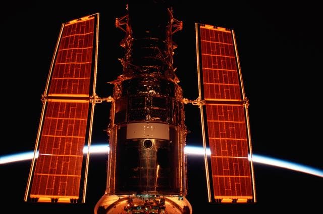 NASA image: HST in Columbia's payload bay during sunrise