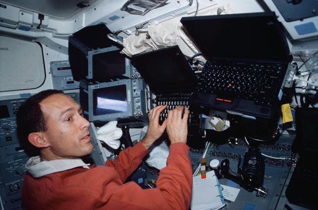 NASA image: MS Newman enters data into a PGSC on flight deck