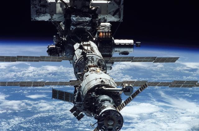 NASA image: Aft zenith view of the ISS backdropped against the Earth's limb taken during STS-111 UF-2 Flyaround