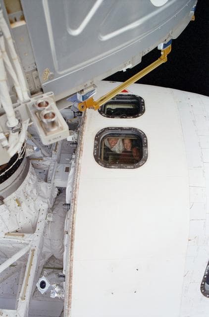 NASA image: CDR Ashby , PLT Melroy and MS Yurchikhin at aft flight deck window