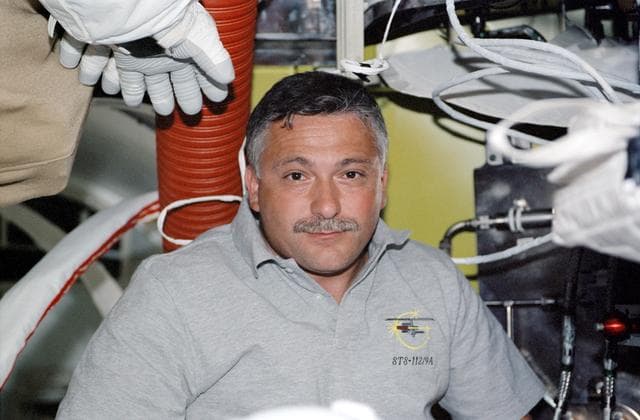 NASA image: STS112 MS Yurchikhin in Quest airlock preparing for EVA 2