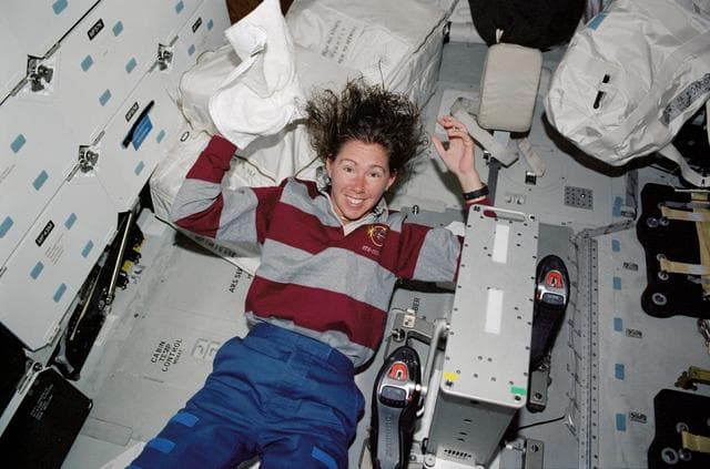 NASA image: STS-112 MS Magnus washes hair on Atlantis middeck