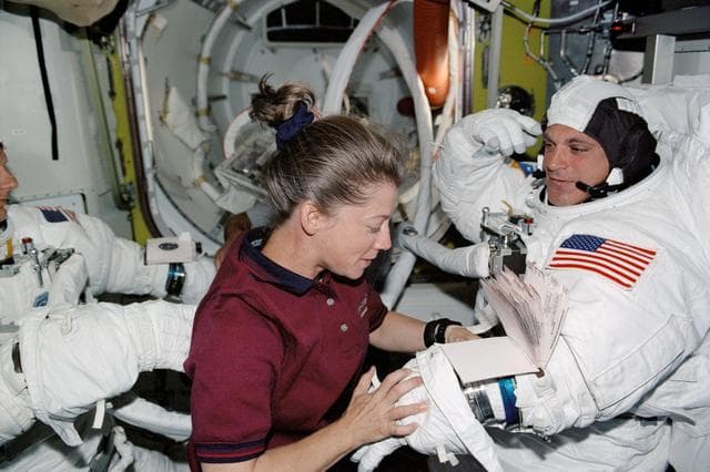 NASA image: STS-112 MS Wolf and PLT Melroy in Quest airlock prior to EVA 2