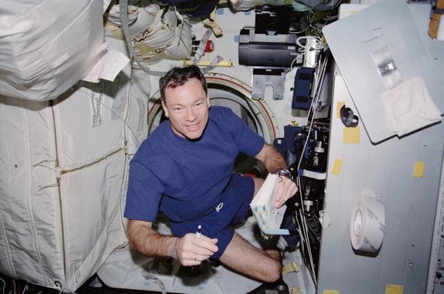 NASA image: Lopez-Alegria in front of Endeavour's MDK hatch during STS-113