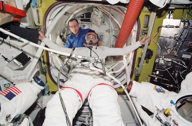 NASA image: Lopez-Alegria during STS-113 EVA 2 pre-breathe ops and EMU don in Quest A/L