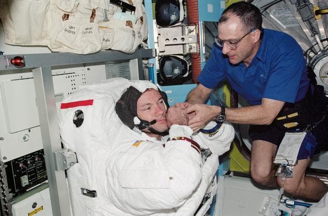 NASA image: Lopez-Alegria and Pettit during STS-113 EVA 2 EMU don in Quest A/L